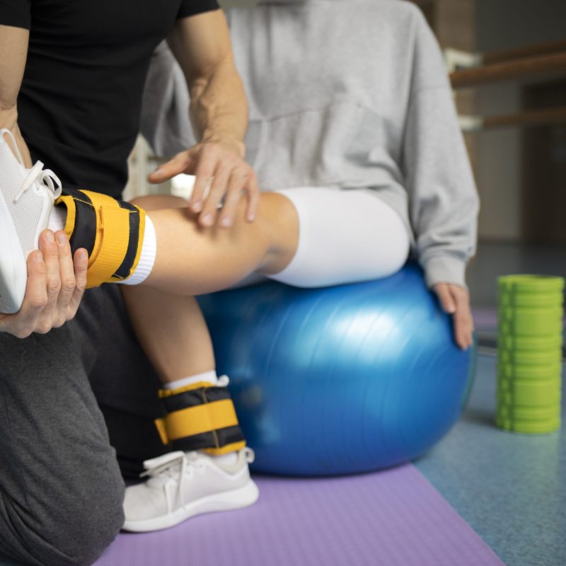 patient-doing-physical-rehabilitation-helped-by-therapists