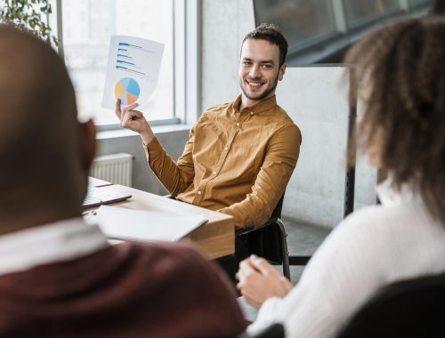 smiley-man-presenting-something-his-colleagues-meeting